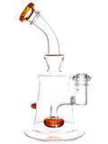 Right: Clear glass pyramid can water rig featuring color accents and a showerhead perc, available for sale at High Roller Smoke in Lakewood, Colorado. 