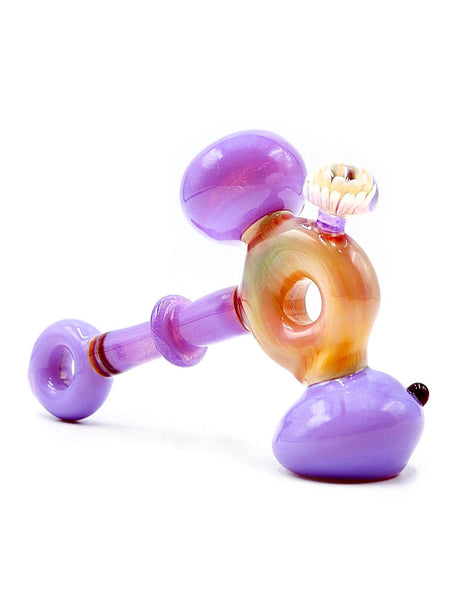 7.5 purple and yellow double donut dry hammer glass hand pipe with encased implosion flower attached, made by American artist for sale at High Roller Smoke in Lakewood, Colorado.