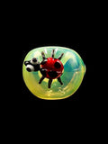 Glass lady bug attached to front of fumed glass hand pipe for sale 
